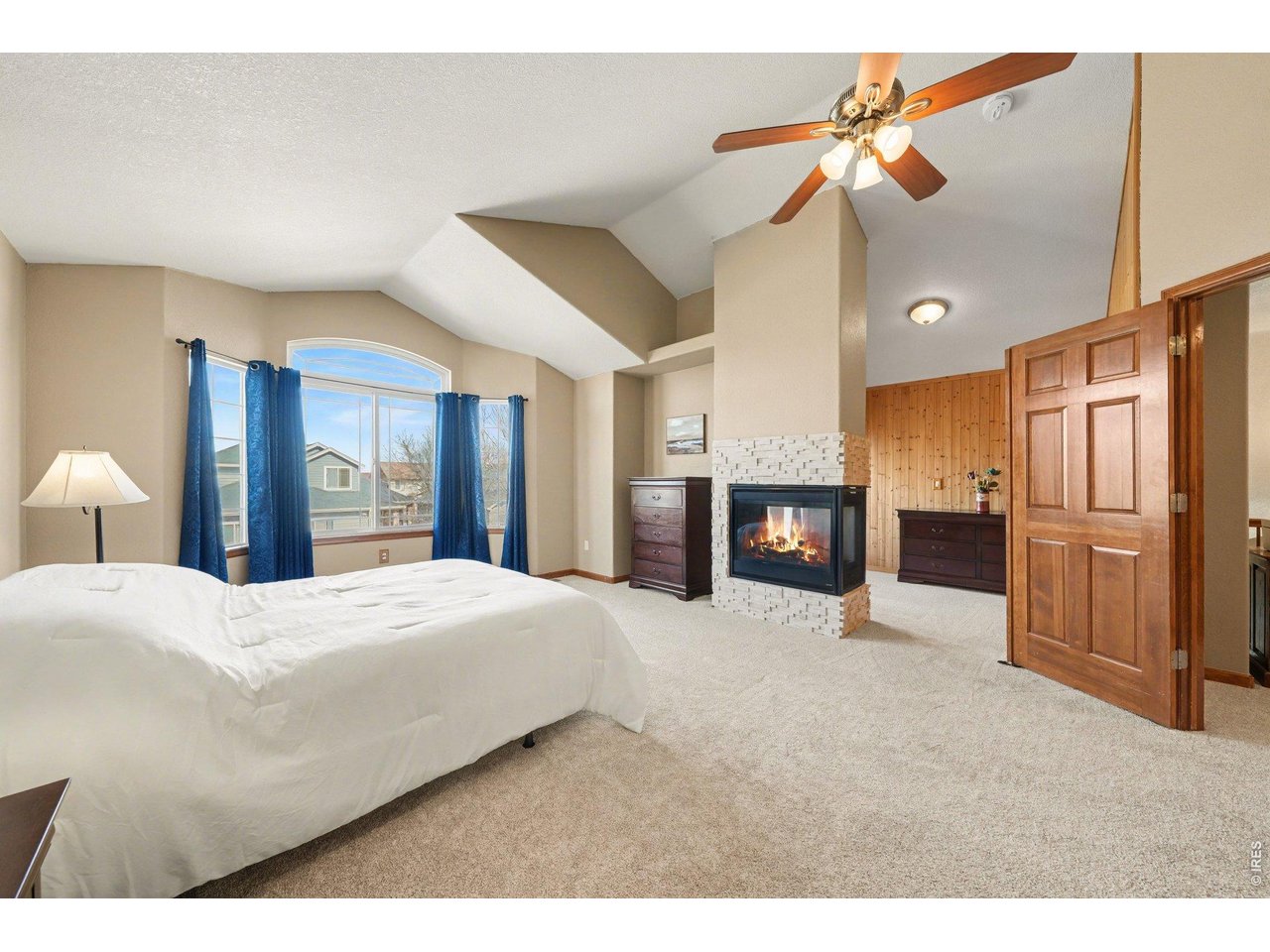 5507 Morgan Way Frederick, CO 80504 - Photo 23 of 45 a large bedroom with a bed and a fireplace