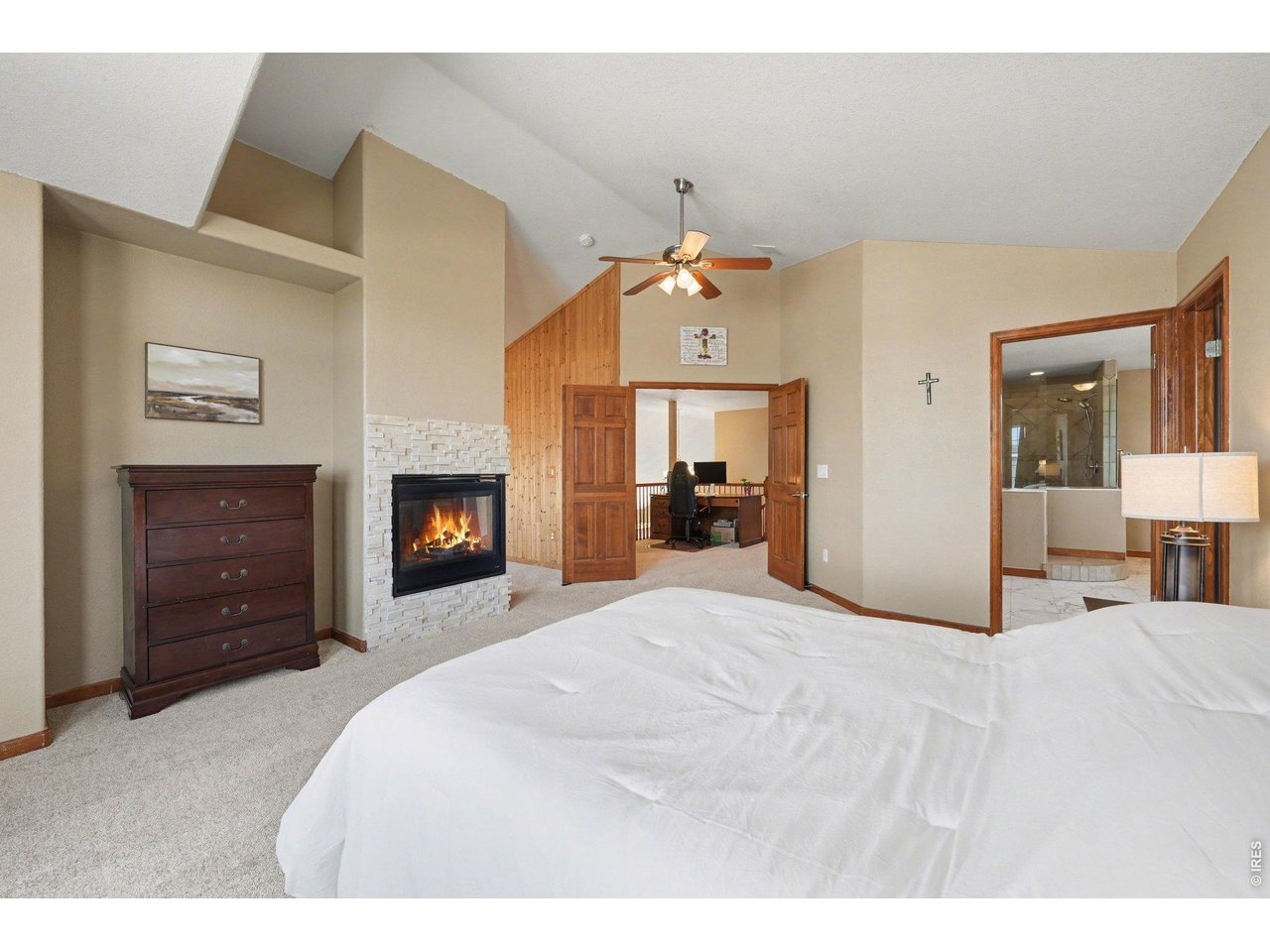 5507 Morgan Way Frederick, CO 80504 - Photo 26 of 45 a large bedroom with a bed and a fireplace