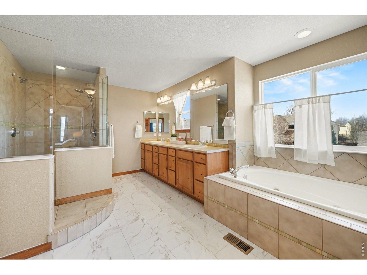 5507 Morgan Way Frederick, CO 80504 - Photo 29 of 45 a large white kitchen with a sink and cabinets