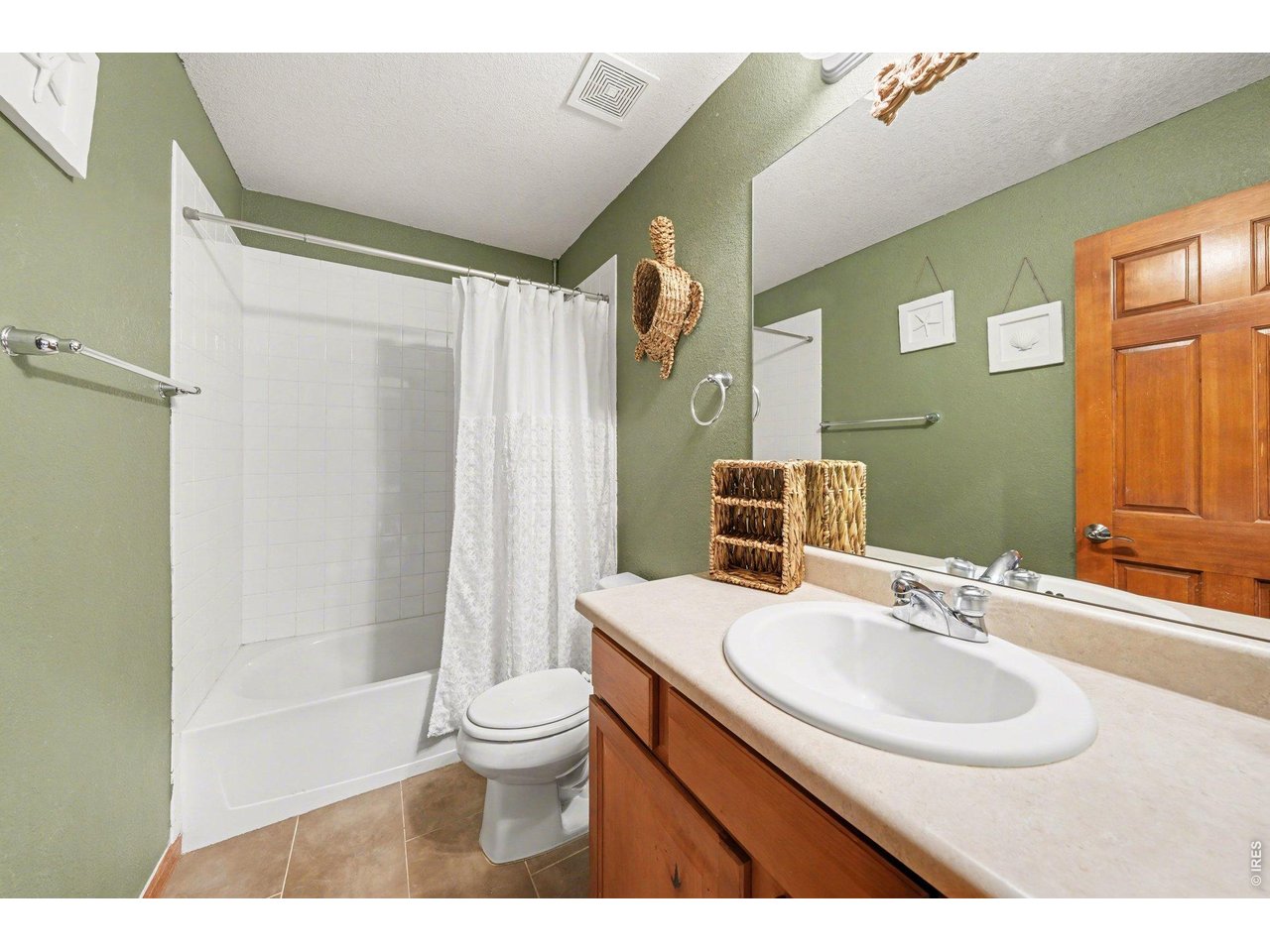 5507 Morgan Way Frederick, CO 80504 - Photo 32 of 45 a bathroom with a sink toilet a mirror and shower