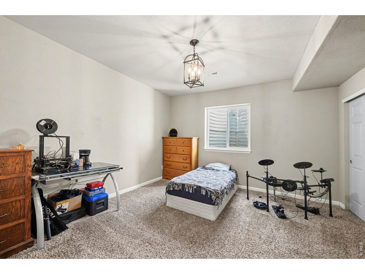 5507 Morgan Way Frederick, CO 80504 - Photo 37 of 45 a living room with furniture and a chandelier