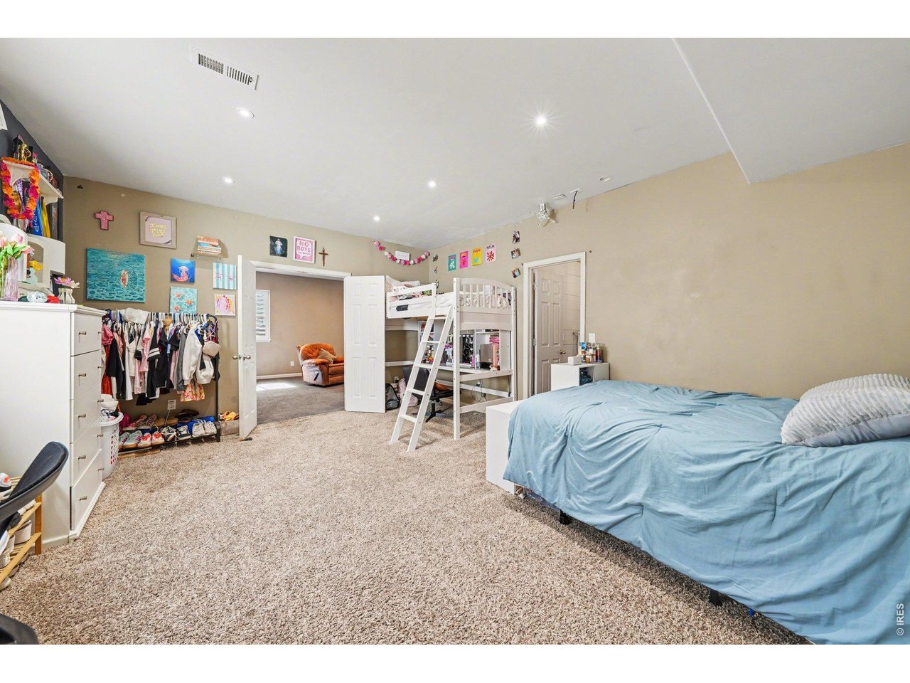 5507 Morgan Way Frederick, CO 80504 - Photo 39 of 45 a bed room with a bed and a walk in closet