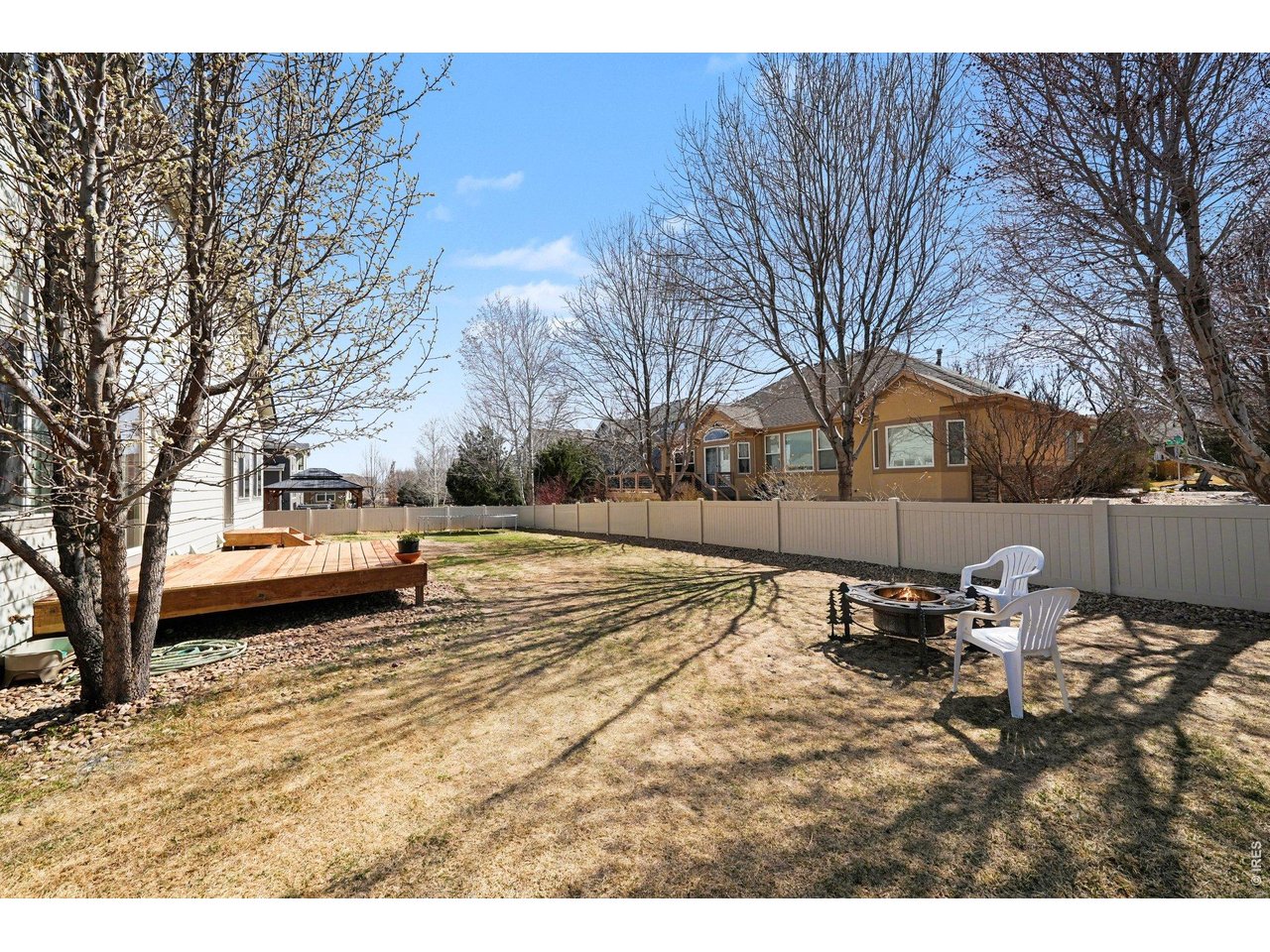 5507 Morgan Way Frederick, CO 80504 - Photo 43 of 45 a backyard of a house with table and chairs