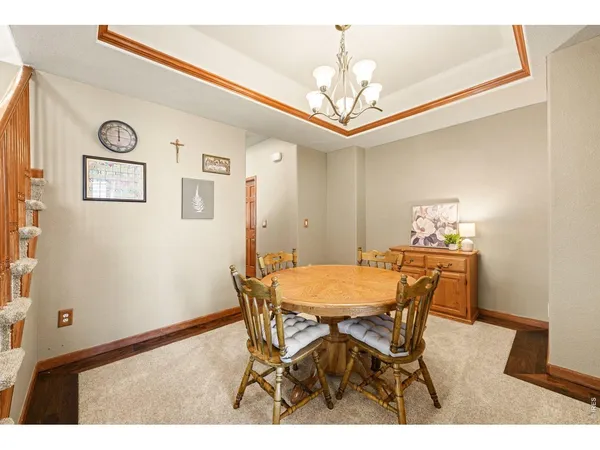 a view of a dining room with furniture and a chandelier