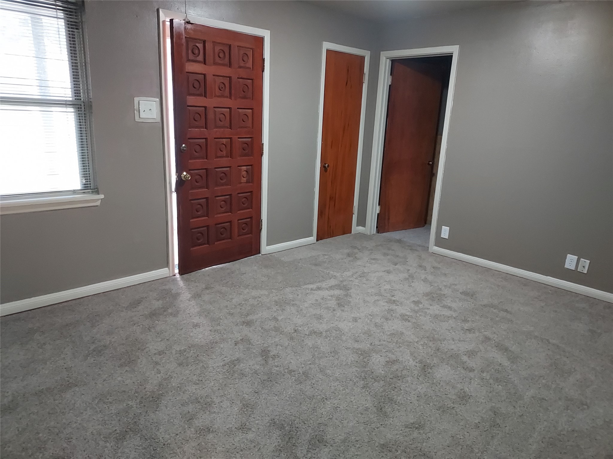 1008 Meadowlane Street Angleton, TX 77515 - Photo 2 of 15 an empty room with windows and closet