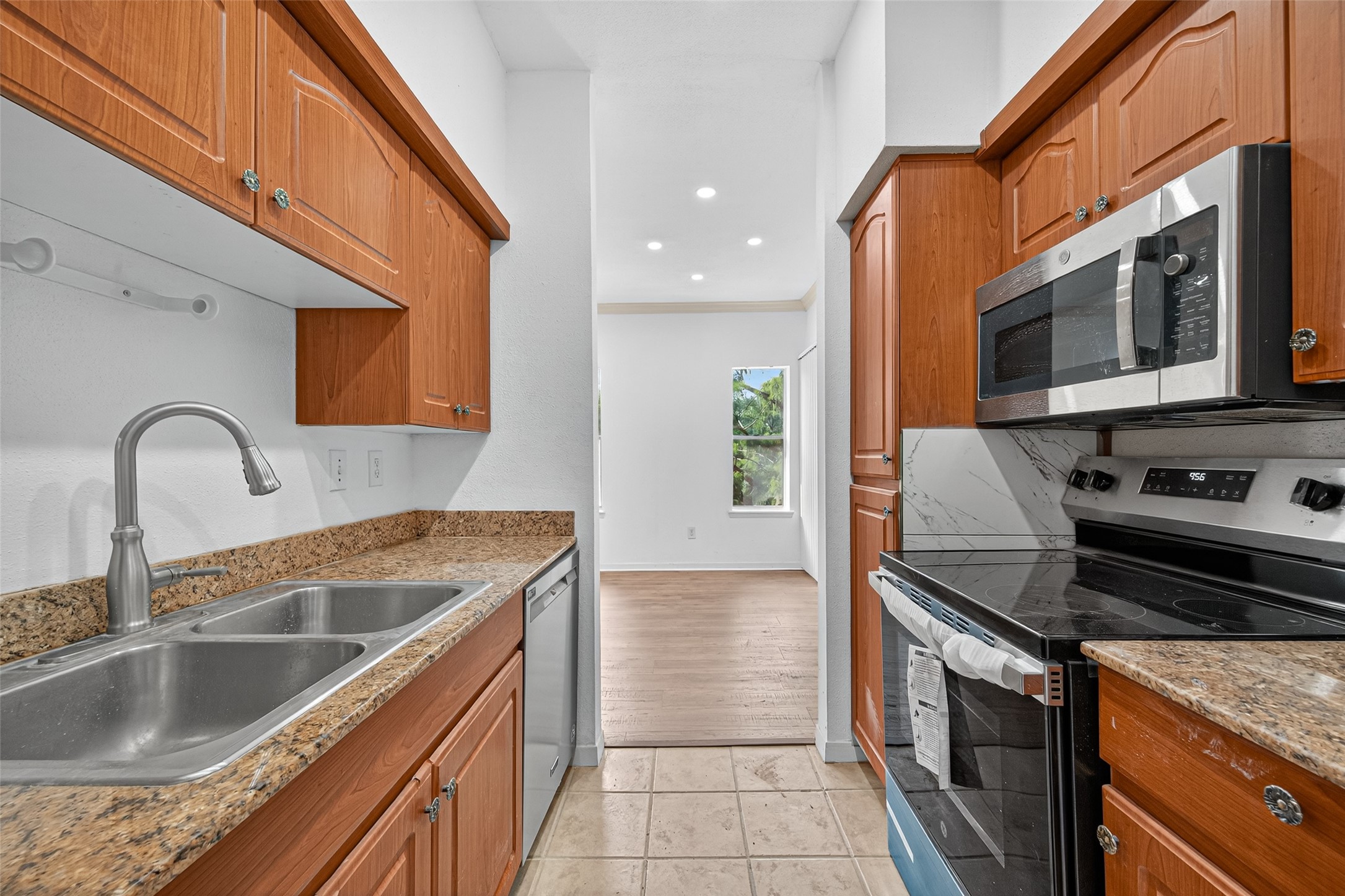 4041 Drake Street, Unit 203 Houston, TX 77005 - Photo 12 of 26 a kitchen with a sink and a stove top oven