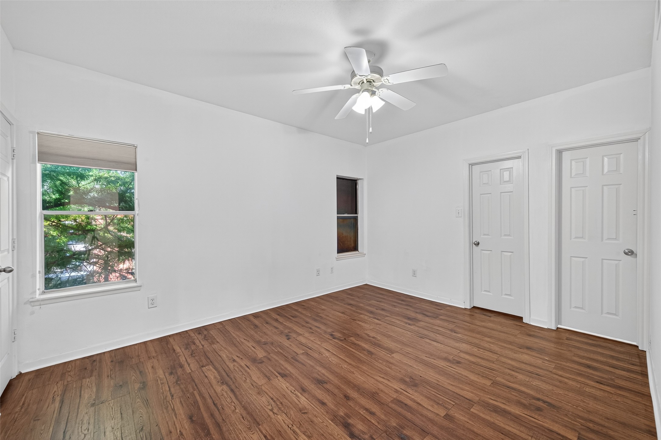 4041 Drake Street, Unit 203 Houston, TX 77005 - Photo 14 of 26 a view of an empty room with wooden floor and a window