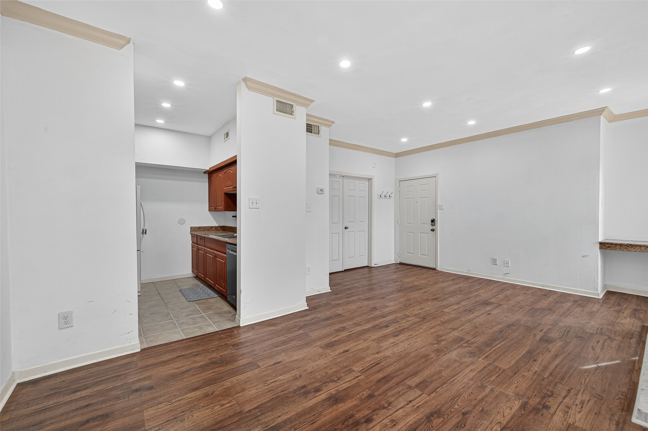 4041 Drake Street, Unit 203 Houston, TX 77005 - Photo 6 of 26 a view of a kitchen with a sink and a refrigerator