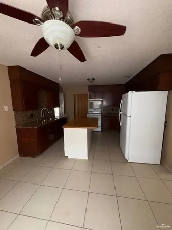 a kitchen with a cabinets and white appliances