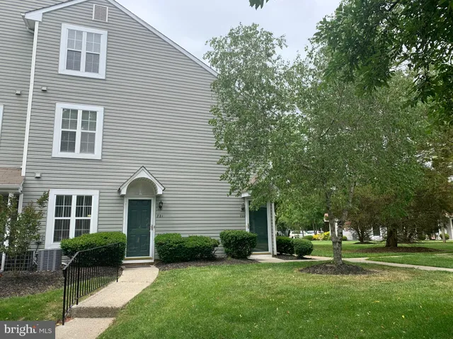 a front view of a house with a garden and yard