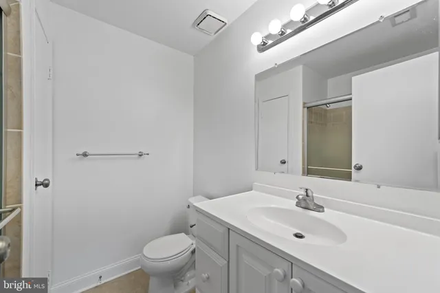 a bathroom with a sink toilet and a mirror