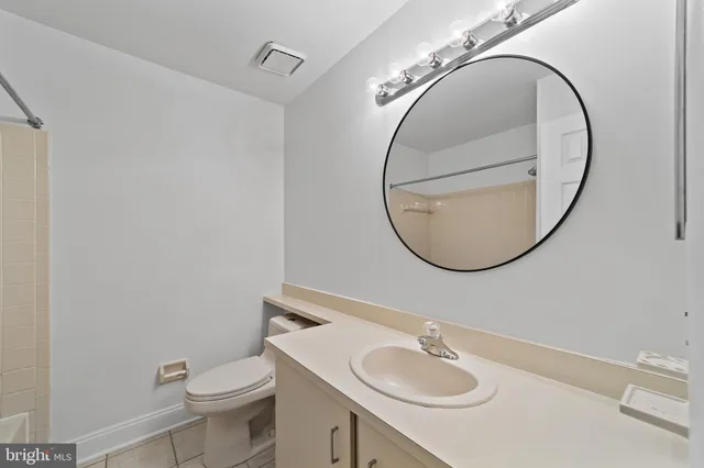 a bathroom with a sink a mirror and a toilet
