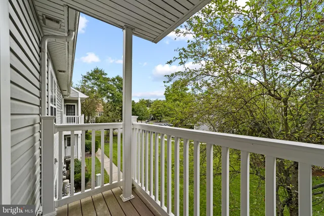a view of a balcony with wooden floor