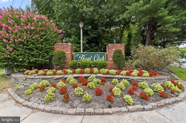 a front view of a house with a yard and fountain