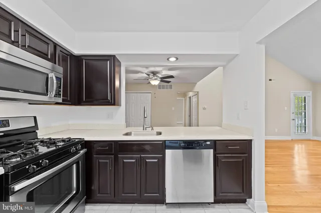 a kitchen with stainless steel appliances a stove and a microwave