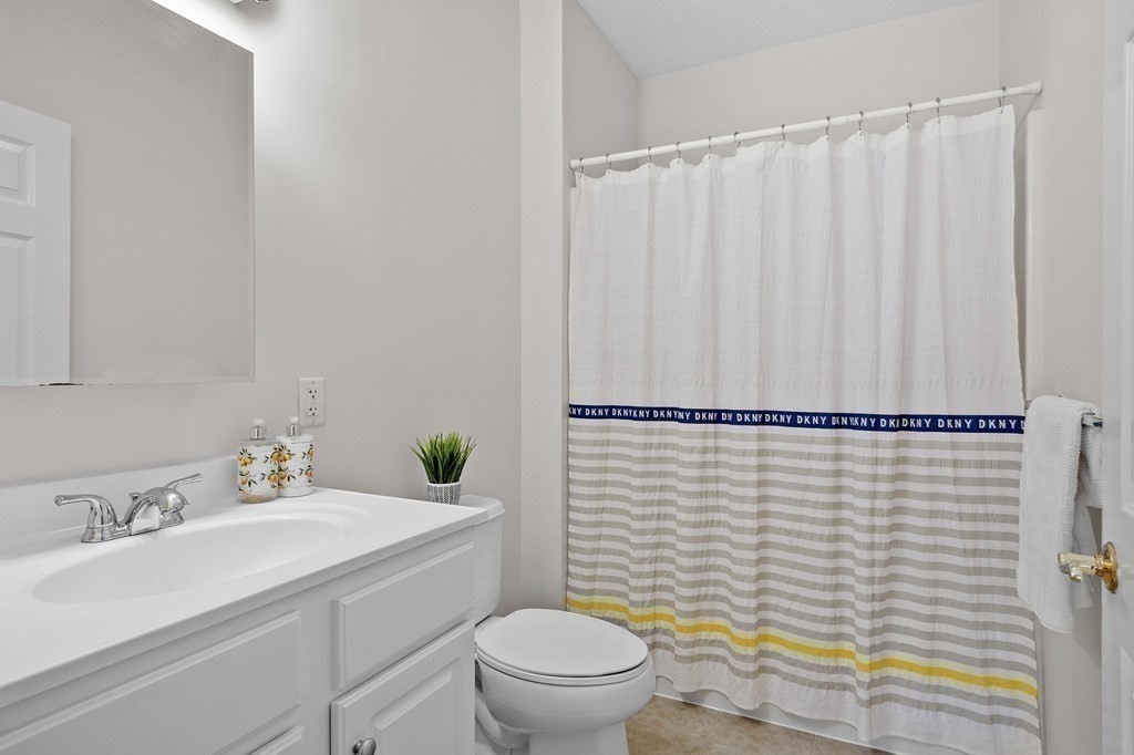 190 Chickering Road, Unit 208D North Andover, MA 01845 - Photo 21 of 42 a bathroom with a sink a toilet and shower curtain