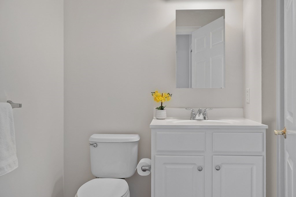 190 Chickering Road, Unit 208D North Andover, MA 01845 - Photo 24 of 42 a bathroom with a toilet sink vanity and mirror