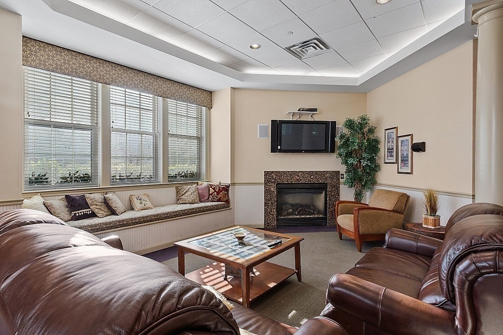 190 Chickering Road, Unit 208D North Andover, MA 01845 - Photo 37 of 42 a living room with furniture large window and a fireplace