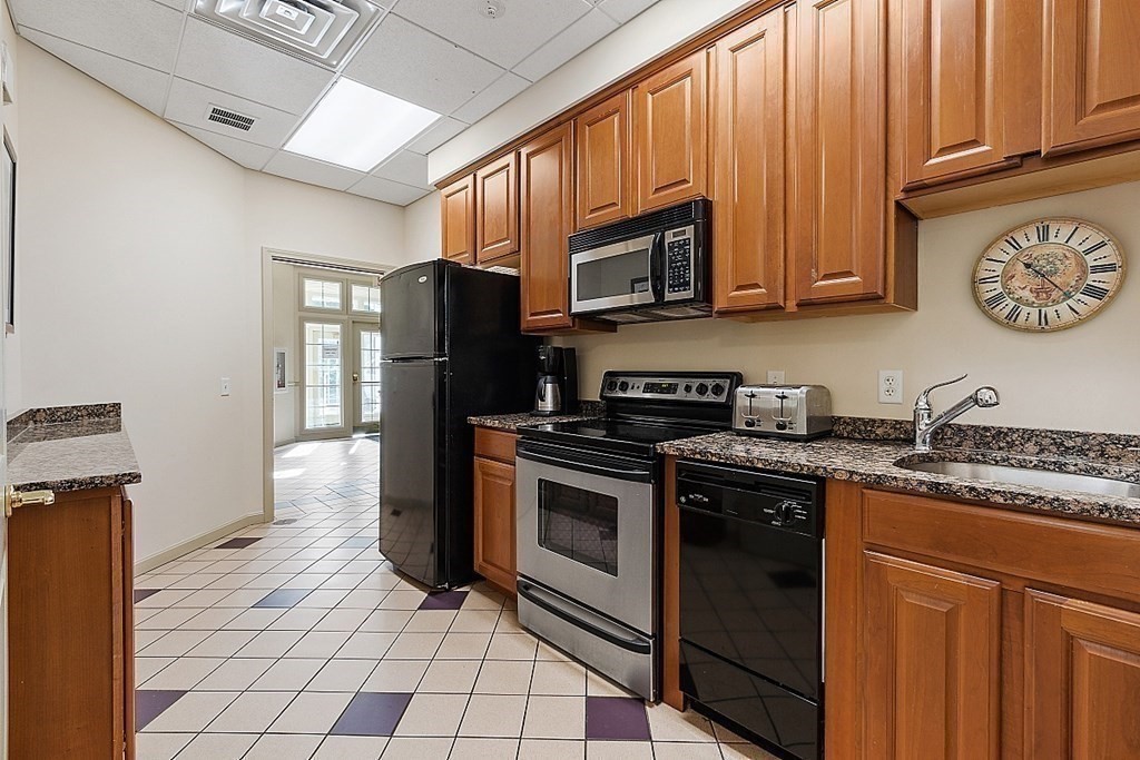 190 Chickering Road, Unit 208D North Andover, MA 01845 - Photo 38 of 42 a kitchen with stainless steel appliances granite countertop a stove a sink dishwasher and a refrigerator