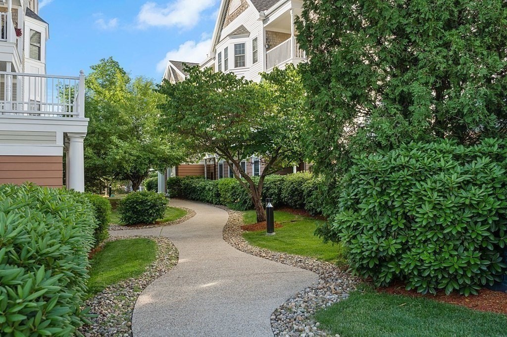 190 Chickering Road, Unit 208D North Andover, MA 01845 - Photo 41 of 42 a view of a white house with a yard and plants