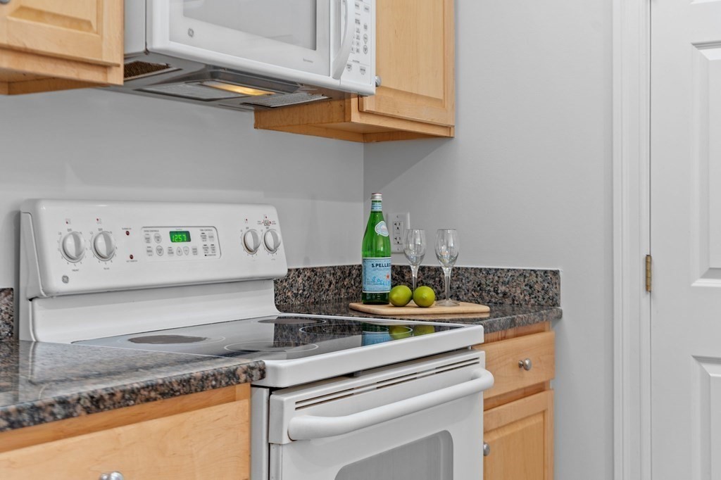 190 Chickering Road, Unit 208D North Andover, MA 01845 - Photo 5 of 42 a kitchen with stainless steel appliances granite countertop a sink and a stove