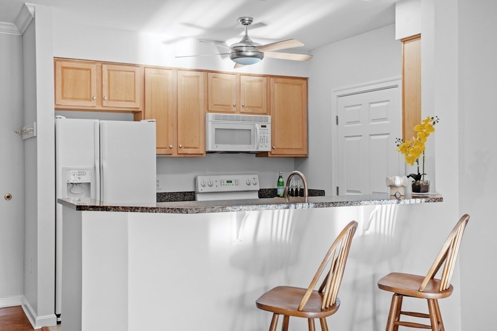190 Chickering Road, Unit 208D North Andover, MA 01845 - Photo 7 of 42 a kitchen with stainless steel appliances granite countertop a sink refrigerator and cabinets
