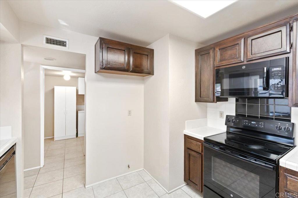17523 Fairlie Road San Diego, CA 92128 - Photo 14 of 33 a kitchen with stainless steel appliances granite countertop a refrigerator and a stove top oven