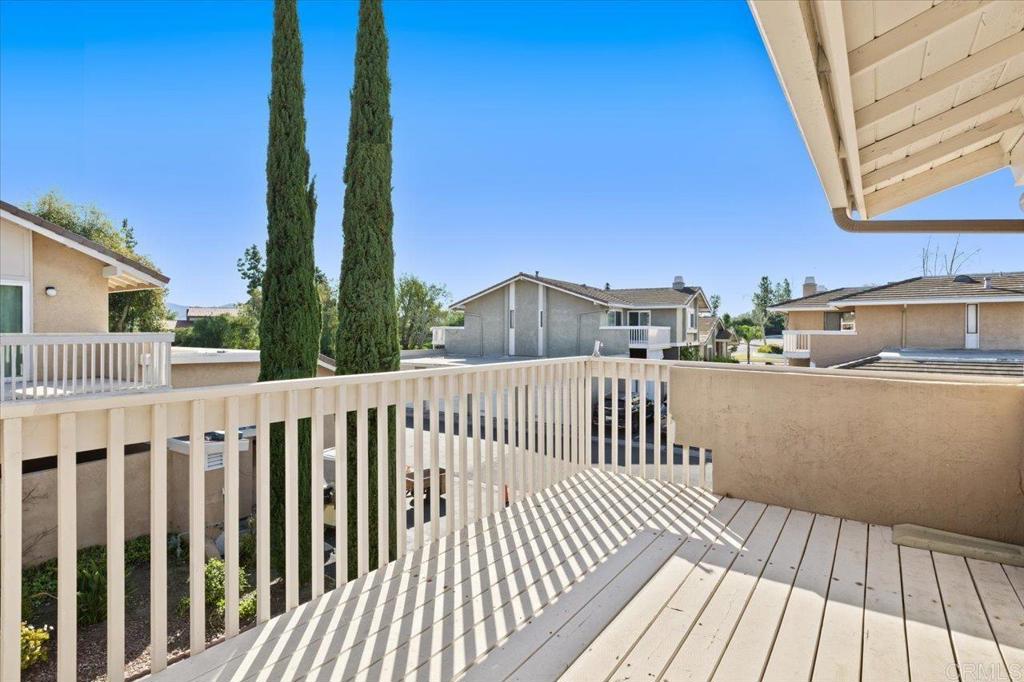 17523 Fairlie Road San Diego, CA 92128 - Photo 24 of 33 a view of a balcony with wooden floor and fence