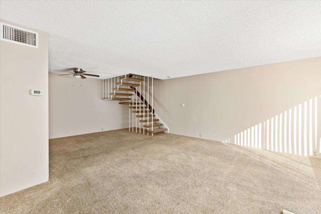 17523 Fairlie Road San Diego, CA 92128 - Photo 6 of 33 a view of a hallway with staircase