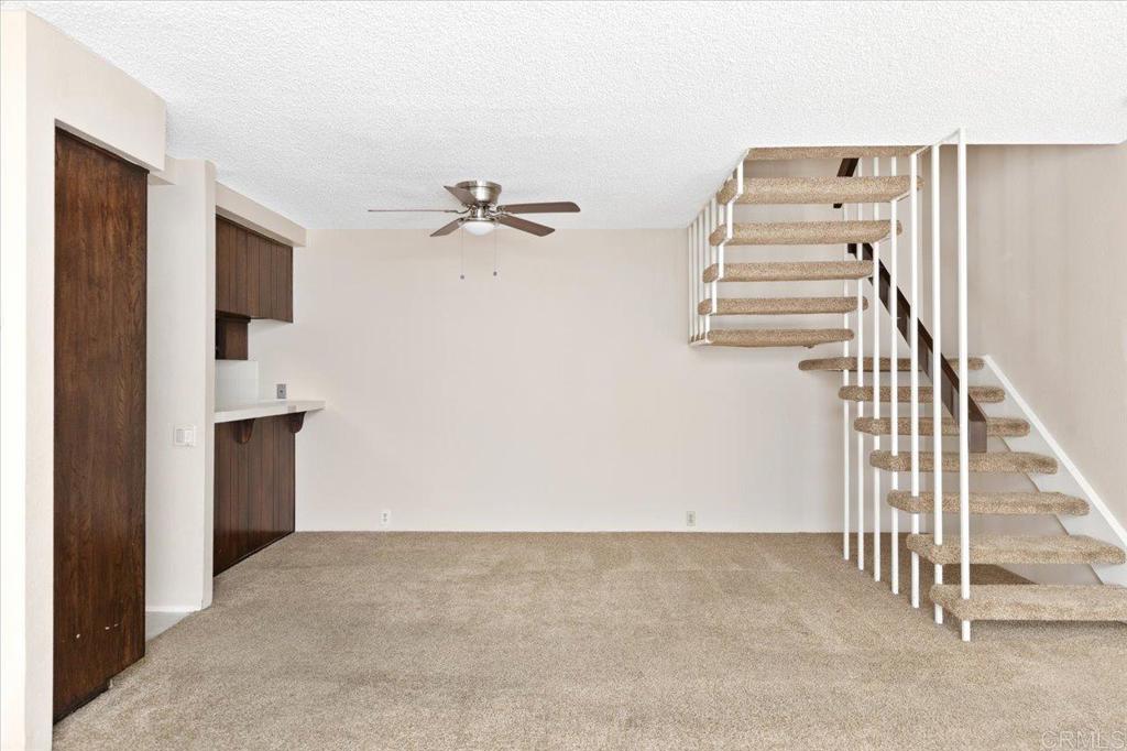 17523 Fairlie Road San Diego, CA 92128 - Photo 9 of 33 a view of a livingroom with a staircase