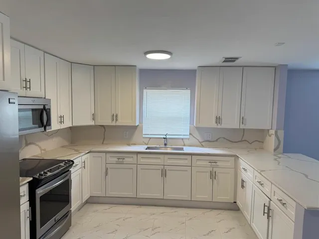 a view of a kitchen with a sink