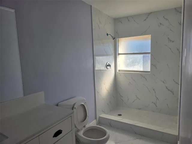 a kitchen with stainless steel appliances granite countertop a sink stove and microwave