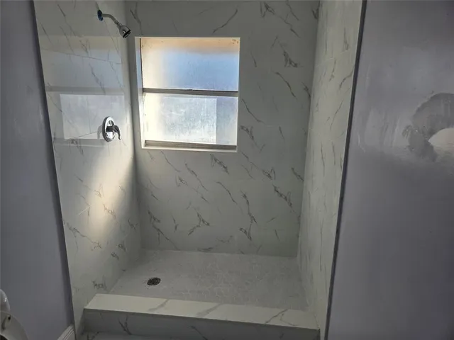 a kitchen with stainless steel appliances a refrigerator and a stove top oven