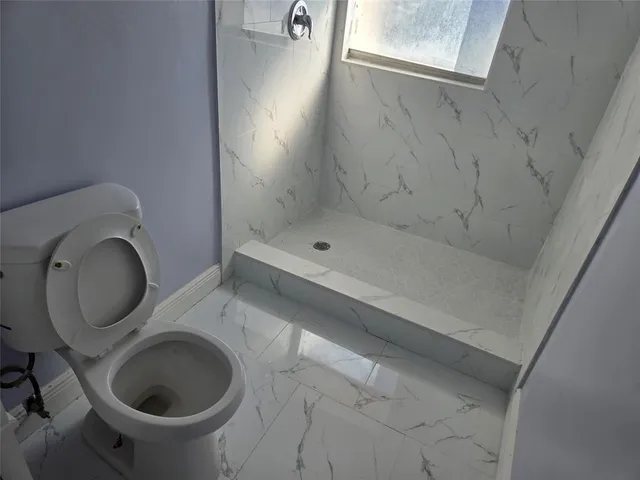 a bathroom with a toilet and a sink