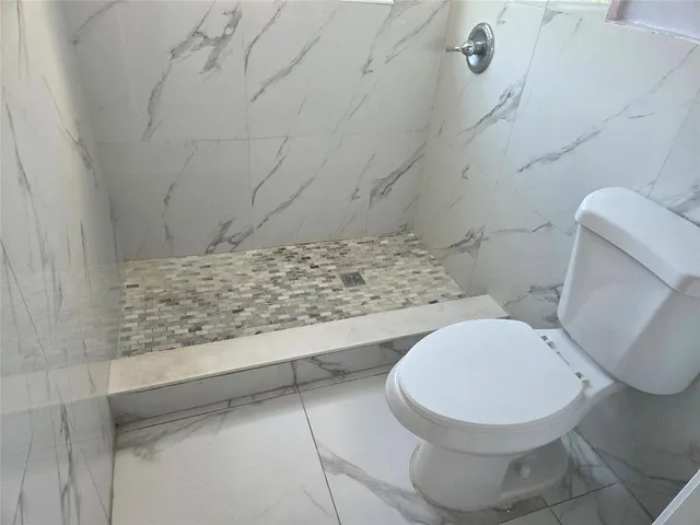 a view of a livingroom with a ceiling fan and window