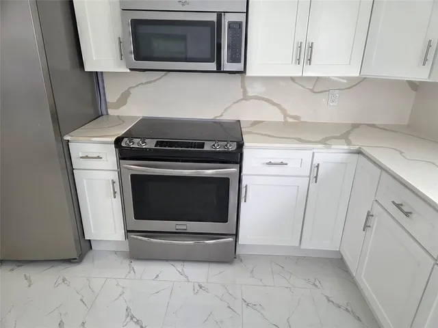 a kitchen with a sink cabinets and window