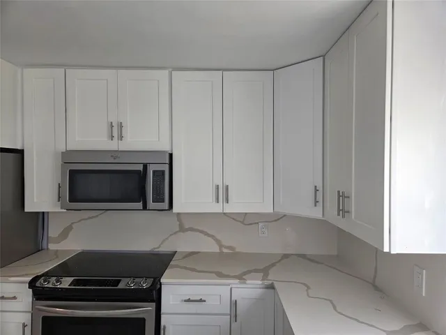 a kitchen with a sink cabinets and window
