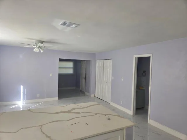 a kitchen with cabinets stainless steel appliances and a counter space