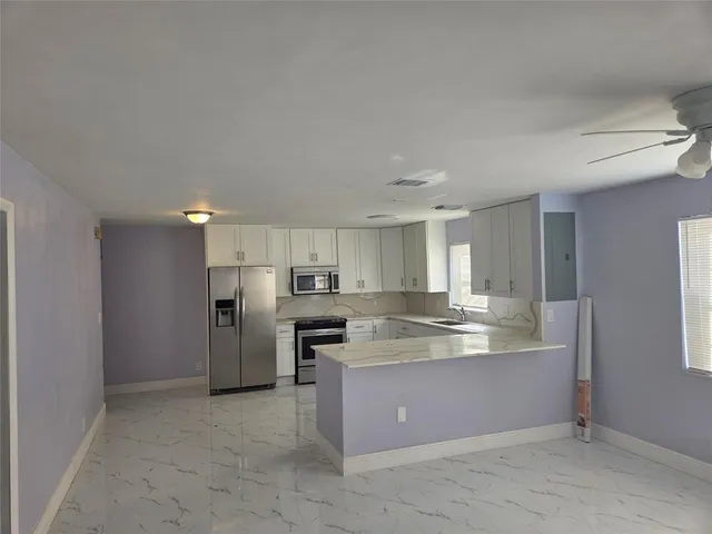 a view of kitchen and refrigerator