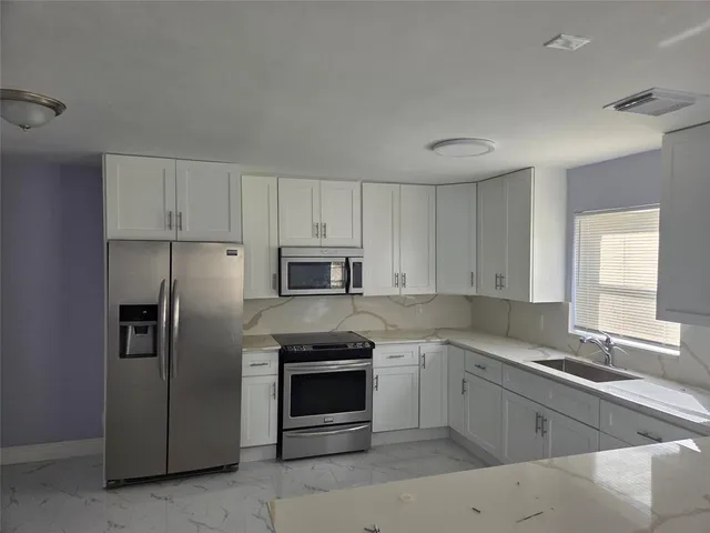 a kitchen with cabinets and sink