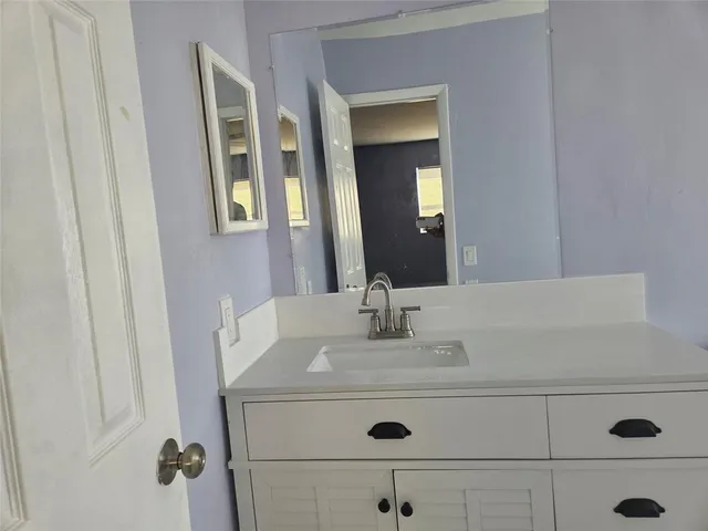a kitchen with stainless steel appliances granite countertop a sink and a stove