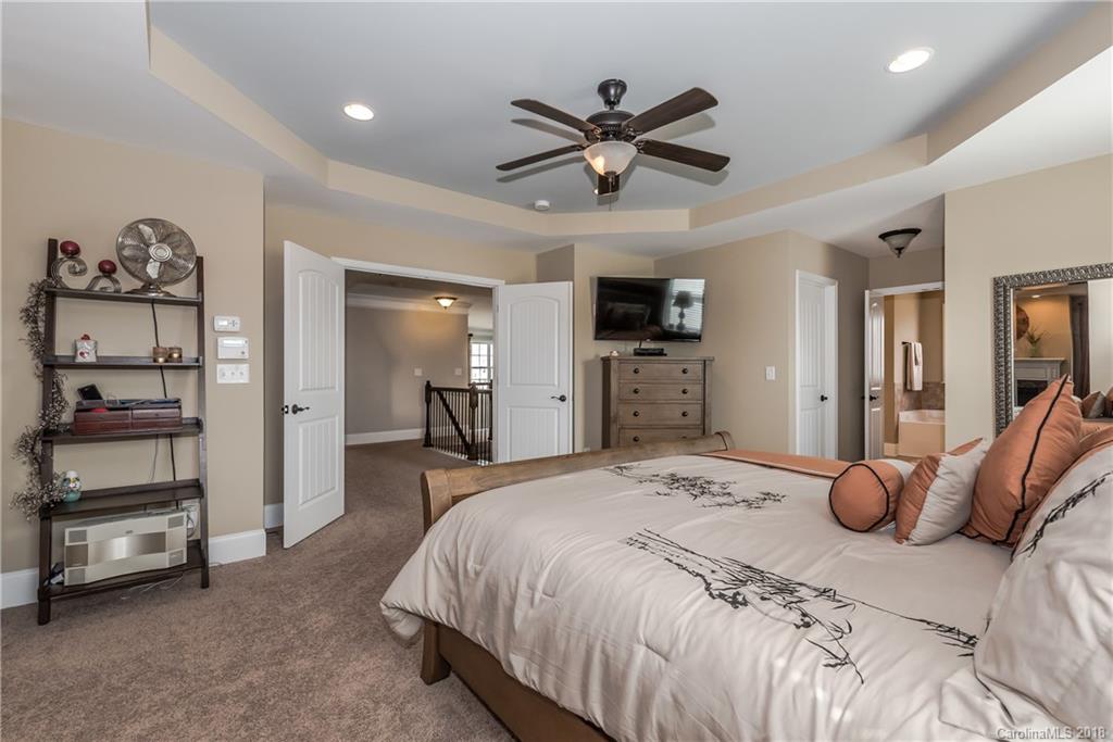 79180 Ridgehaven Road Lancaster, SC 29720 - Photo 13 of 24 a bedroom with a bed and a chandelier
