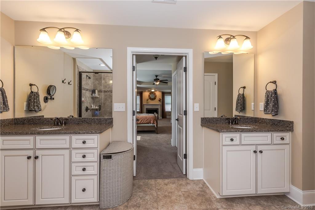79180 Ridgehaven Road Lancaster, SC 29720 - Photo 16 of 24 a en suite bathroom with granite countertop a sink and a mirror