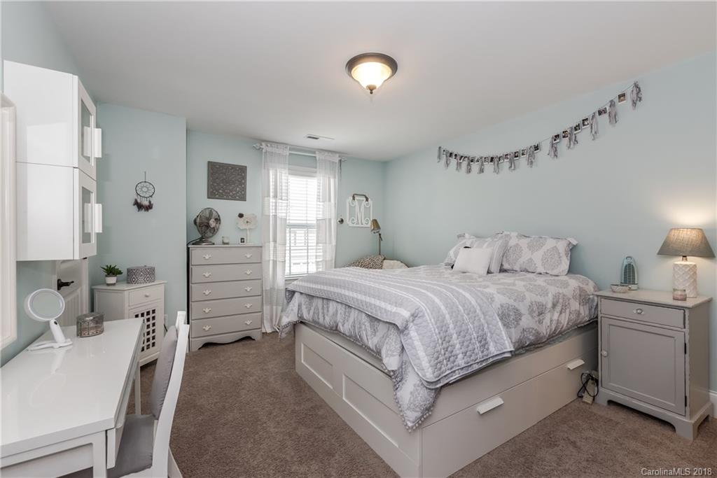 79180 Ridgehaven Road Lancaster, SC 29720 - Photo 17 of 24 a spacious bedroom with a bed and a lamp