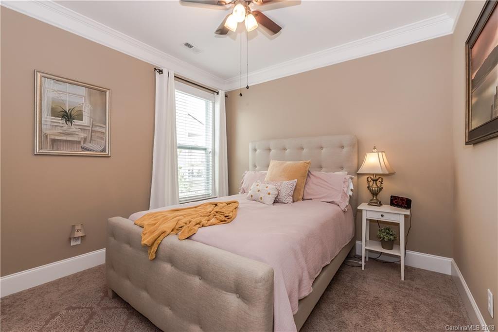 79180 Ridgehaven Road Lancaster, SC 29720 - Photo 20 of 24 a bedroom with a bed and a chandelier
