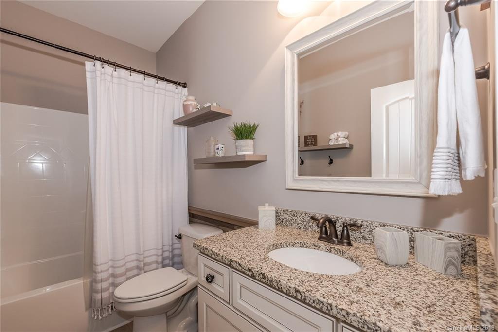 79180 Ridgehaven Road Lancaster, SC 29720 - Photo 21 of 24 a bathroom with a granite countertop sink toilet and shower