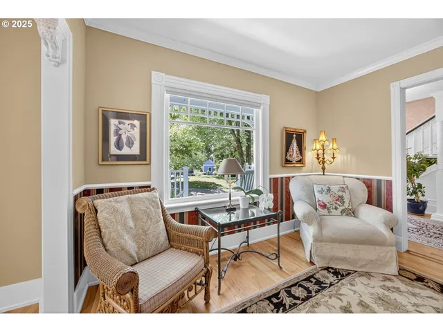 a dining room with wooden floor a chandelier a wooden table and chairs