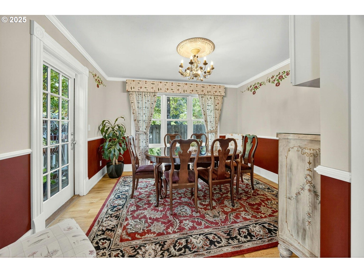 496 Beach Street Ashland, OR 97520 - Photo 13 of 45 a dining room with wooden floor a chandelier a wooden table and chairs