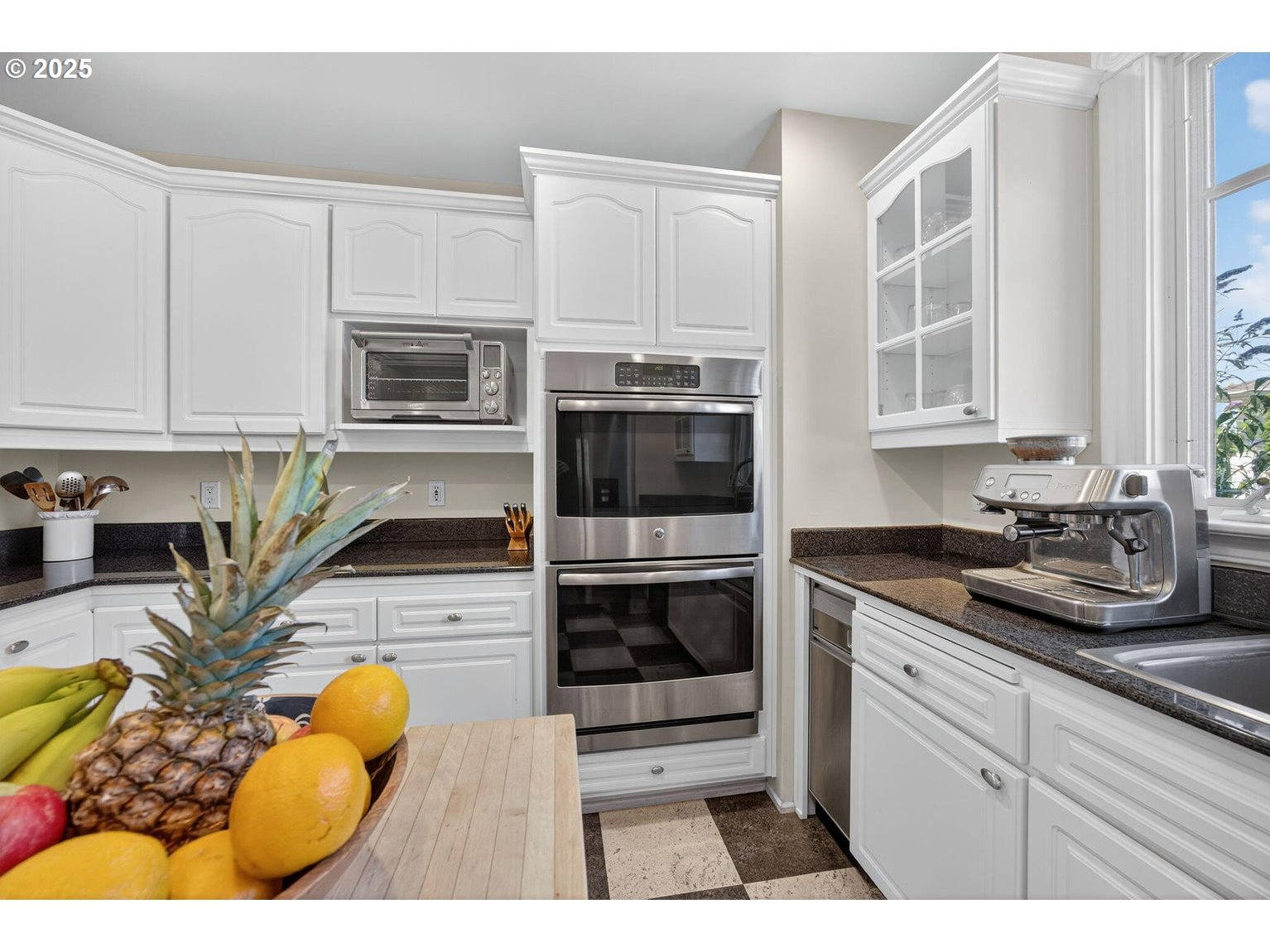 496 Beach Street Ashland, OR 97520 - Photo 15 of 45 a kitchen with stainless steel appliances kitchen island granite countertop a stove a sink and a microwave