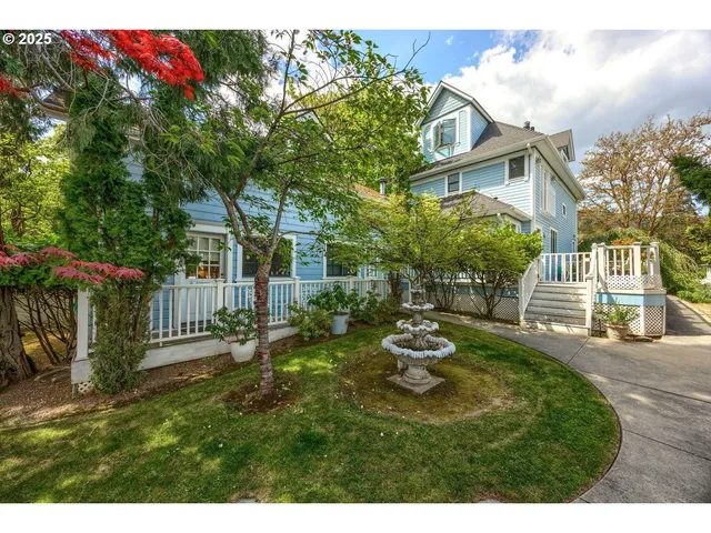 a view of a house with a small yard and wooden fence